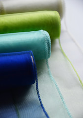 Reels organza ribbon pastel colors white blue green isolated white background. Design concept for...