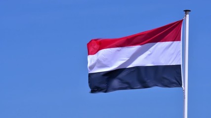 Dutch tricolour flag, national flag of the Netherlands blowing in the wind from flagpole - Powered by Adobe