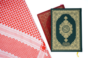 Quran and shemagh fabric - holy book of Muslims - Koran - quran on white background
