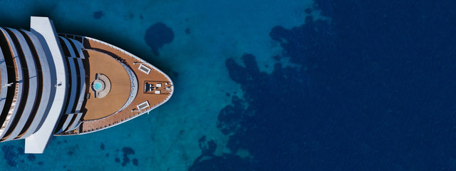 Aerial drone ultra wide photo of cruise liner nose cruising in Mediterranean Aegean deep blue sea