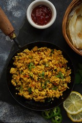 Scrambled eggs/ Masala egg Bhurji served with roti, selective focus