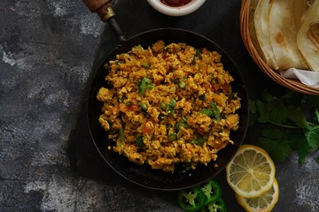 Scrambled eggs/ Masala egg Bhurji served with roti, selective focus