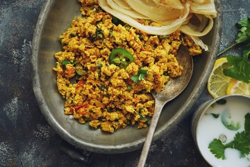 Scrambled eggs/ Masala egg Bhurji served with roti, selective focus