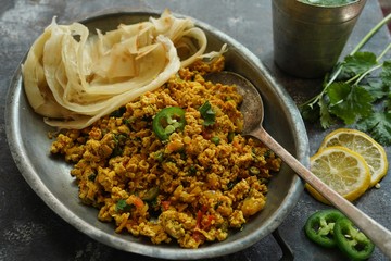 Scrambled eggs/ Masala egg Bhurji served with roti, selective focus