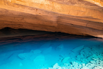 Transparent blue water pond inside cave in Brazil