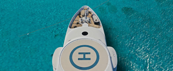 Aerial drone ultra wide photo of mega yacht nose docked in tropical exotic island bay with...