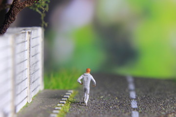 Obraz premium Illustration Photo, Cheap and Easy Sport in the morning, Alone Mini Figure Sport Man Toy at Asphalt Road 