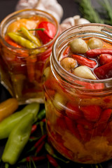 Fototapeta na wymiar top view jar of red peppers pickled in olive oil