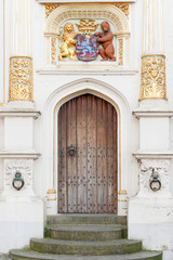 Exquisite entrance of medieval Justice Palace with Brugge coat of armes on the Burg square, Bruges, Belgium