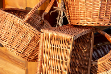 Many yellow wicker straw baskets in the street piled up.