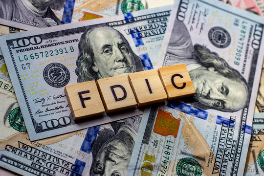 The Word Fdic On Dollar Usa Background. USA Federal Deposit Insurance Corporation Concept.