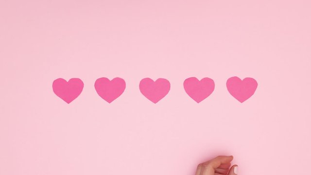 Woman hand put five pink heart for Valentine's day - Stop motion 