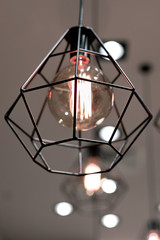 Ceiling light with a frame lampshade with a vintage incandescent bulb in a commercial room