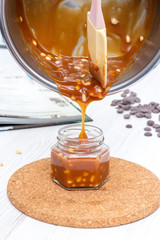 Pouring toffee in a cup from a pan