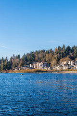 View over inlet, ocean and island with boat and mountains in beautiful British Columbia. Canada.