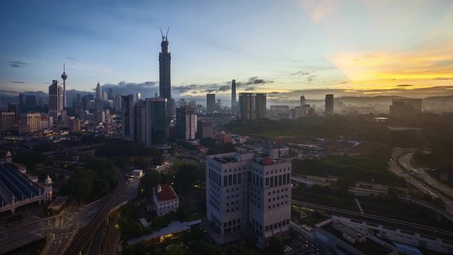 4k time lapse of sunrise at Kuala Lumpur city horizon, aerial view. Tilt up