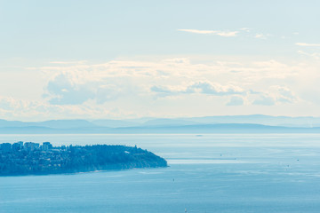 View over inlet, ocean and island with boat and mountains in beautiful British Columbia. Canada.