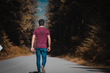 man walking on country road