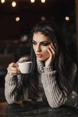 Beautiful woman drinking coffee sitting in a cafe.