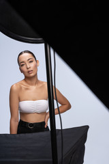 Asian beautiful woman standing near studio light set