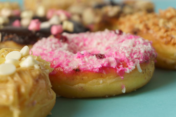 close up on doughnuts against aqua surface. selective focus