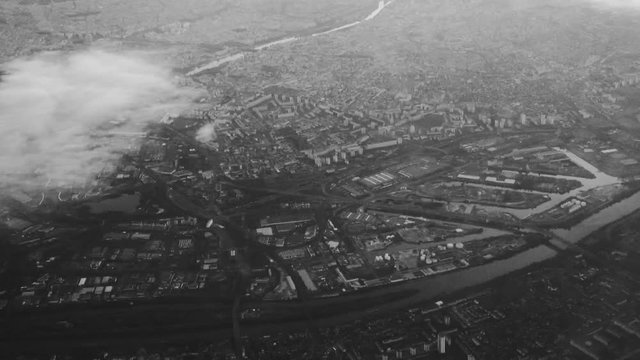 Airplane view of Paris and Seine River from above the clouds. Black and white