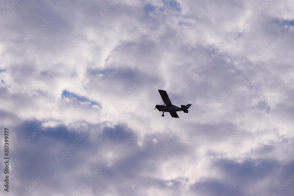 Wall mural Airplane in the Clouds