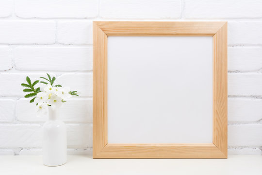 Wooden square frame mockup with Tobacco flowers