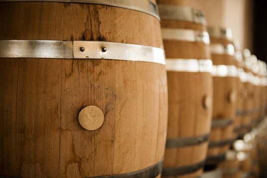 Fototapeta wooden barrels of wine in a cellar