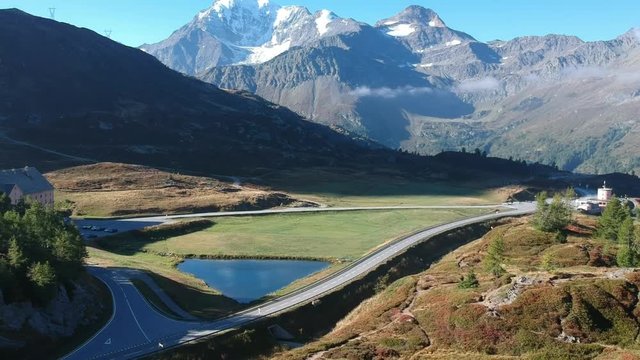 Drone shot from a small lake at the Simplon pass, with the alps in the background, Switzerland
