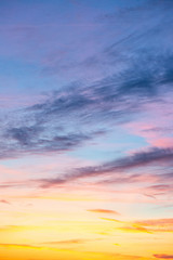 Evening sunset sky with bright rays of the sun and beautiful colorful clouds