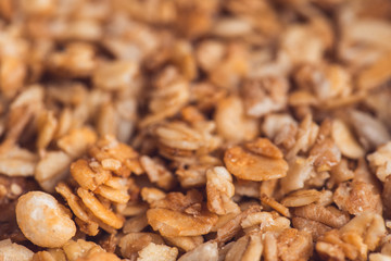 Useful and tasty muesli with nuts, rasins and flakes. Selective focus macro shot with very shallow depth of field. Healthy and vegetarian lifestyle