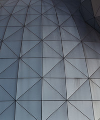 Metallic geometric shapes on the the wall of a building