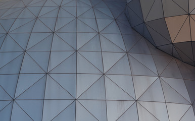 Metallic geometric shapes on the the wall of a building