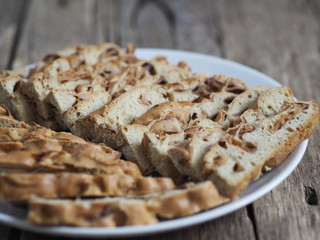 Homemade baking. Traditional apple pie, cupcake with dried apples, closeup presented on a wooden table. Home cooking.