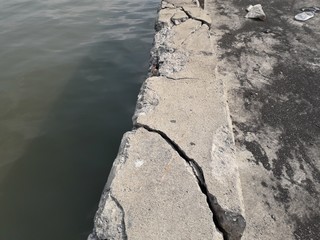 The damaged wall is visible to the internal steel bar. The plaster should be repaired With mortar to make it work.	
