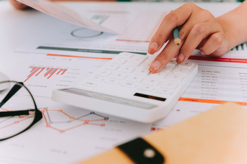Close up Accountants use calculator analysis financial from financial statement reports