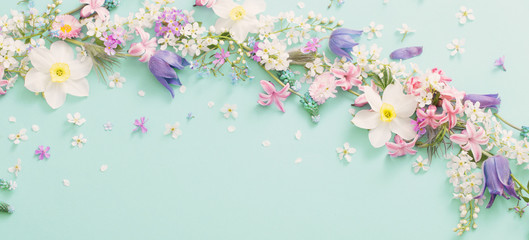 beautiful spring flowers on green paper background