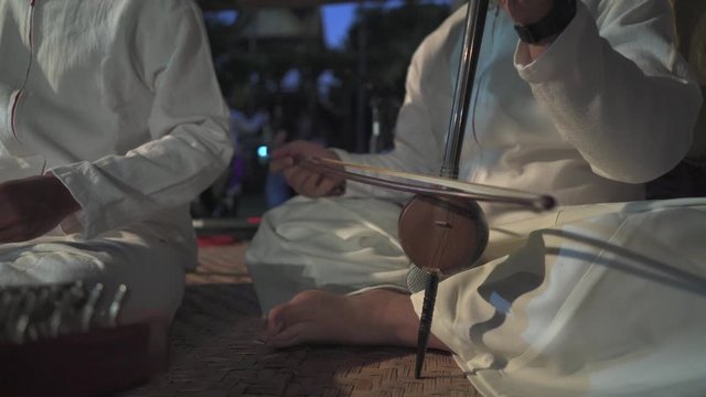Man playing on on Chinese Hammered Dulcimer 