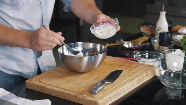 Close-up of dessert, cook in kitchen put tablespoon of thick sour cream in brilliant deep bowl, lot of sour cream, professional prepare delicious dish, sauce, filling, cream, adding another ingredient