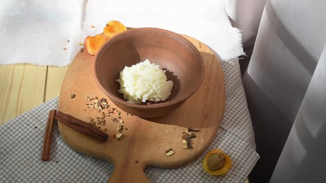 Girl puts freshly cooked rice milk porridge in clay dishes