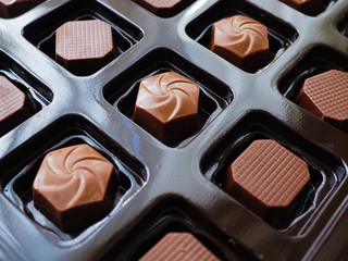Close up photo of assorted chocolates in a box.