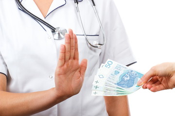 Woman doctor refusing bribes or kickbacks, concept of corruption