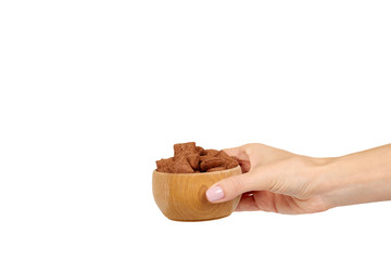 Chocolate pillow cereal, breakfast food. Crunchy snack with oat and corn. Wooden bowl.