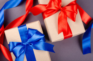 Gift box on dark background composition, present with ribbon and bow.