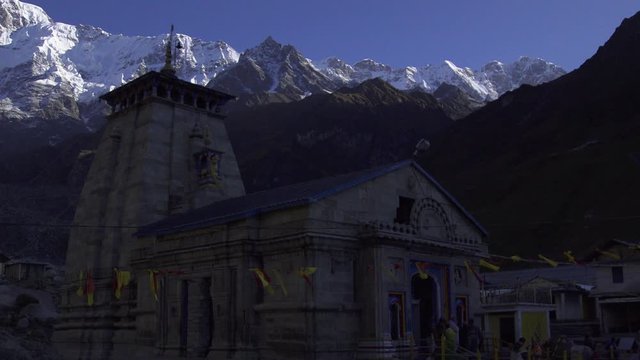 Timelapse Kedarnath Temple Uttarakhand India, Himalayas. Morning timelapse view of Kedarnath temple. Kedarnath peak in background. Pilgrims at Kedarnath Temple, upper Himalayas, Uttarakhand India.