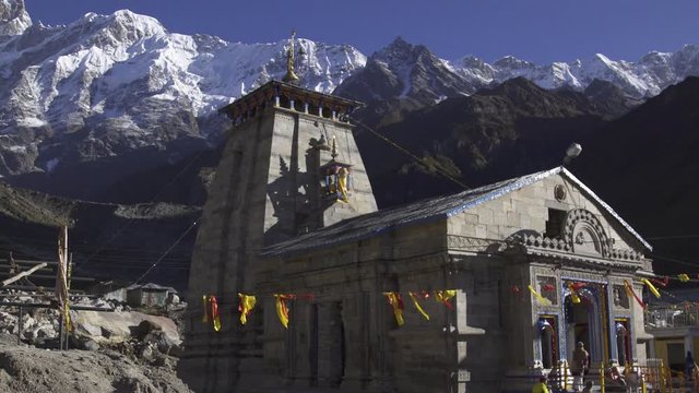 Kedarnath, Uttarakhand, India- Beautiful shot of Kedarnath temple & Kedarnath dome ( Peak) at the background, Garhwal Himalaya Range. Kedarnath Temple shrine. Devotees at Holy Temple.Hindus religious