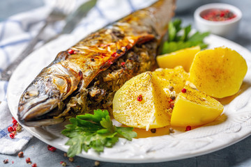 Baked mackerel stuffed with herbs and onions.
