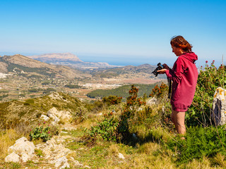 Woman take photo in mountains