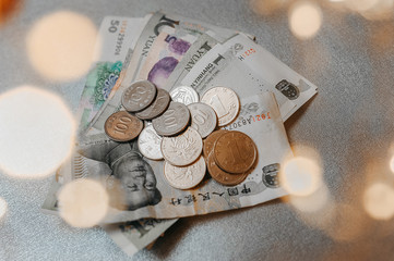 Chinese coins of different values and yuan paper money on a single textile background with a...